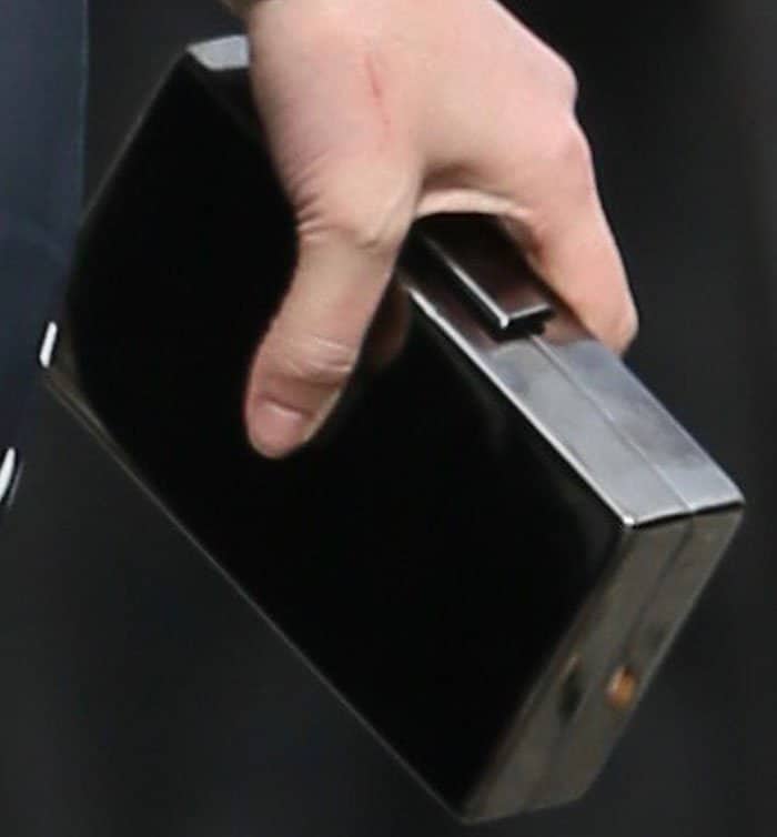 Katherine keeps things muted with an Edie Parker clutch