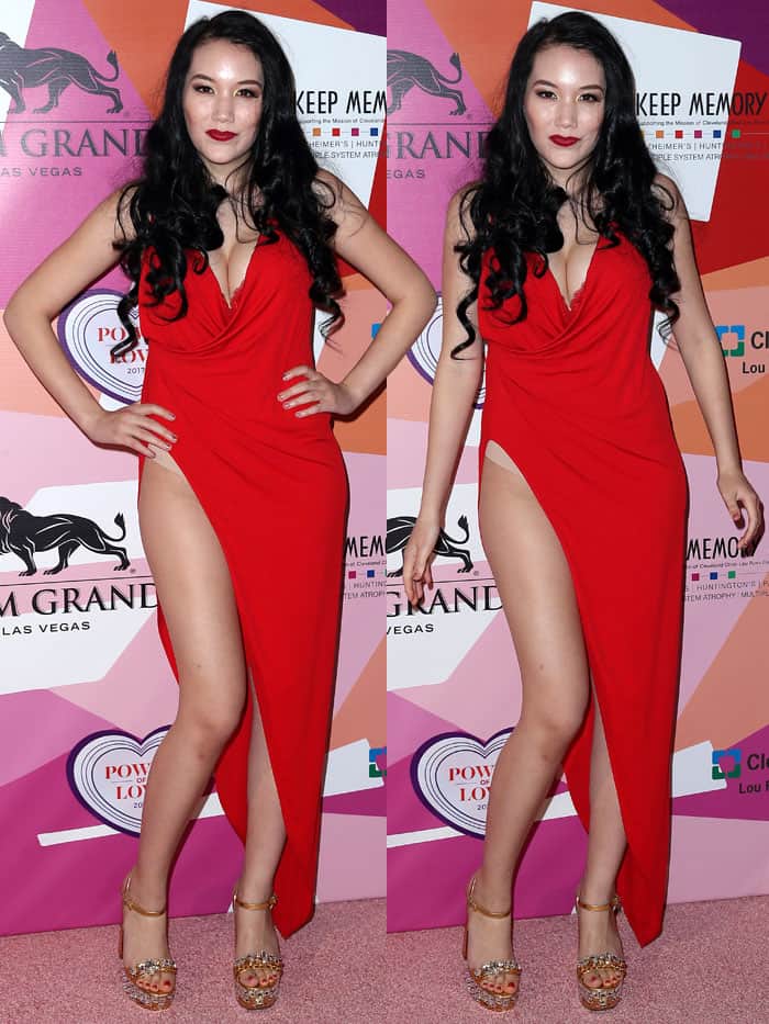 Manika Ward turned heads at the Power of Love Gala in a plunging red gown with a daring thigh-high slit, finishing the look with sparkling crystal-embellished gold Miu Miu platform sandals