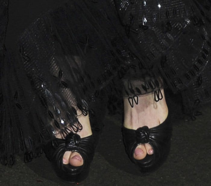 At the New York screening of 'Colossal,' Anne Hathaway steps out in the iconic Christian Louboutin 'Marchavekel' sandals, showcasing luxury and style