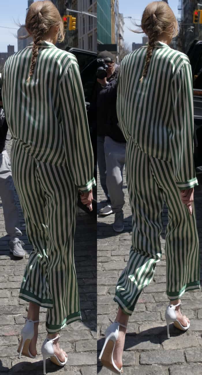 Gigi shows off the fluid movement of her striped silk Morgan Lane set as she walks through the city in her white Stuart Weitzman stilettos