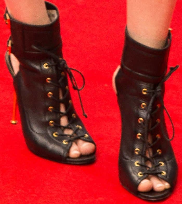 Alexandra Daddario added a bold finish to her look with Tom Ford lace-up peep-toe ankle boots, crafted in smooth black leather with gold eyelets and stiletto heels that perfectly echoed her outfit’s sleek, modern edge
