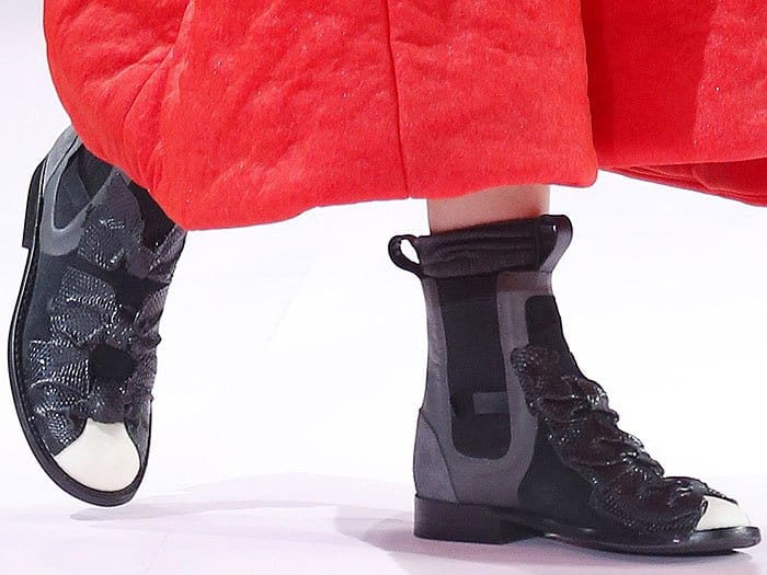 Studio view of the black leather Comme des Garçons x Nike Fall 2017 bow boots
