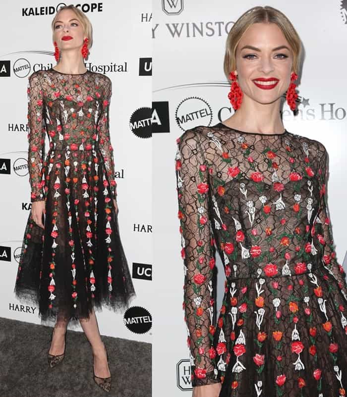 Jaime King stuns in a sheer black tulle dress embroidered with red and white florals, pairing the romantic look with pointed-toe lace pumps for an elegant finishing touch