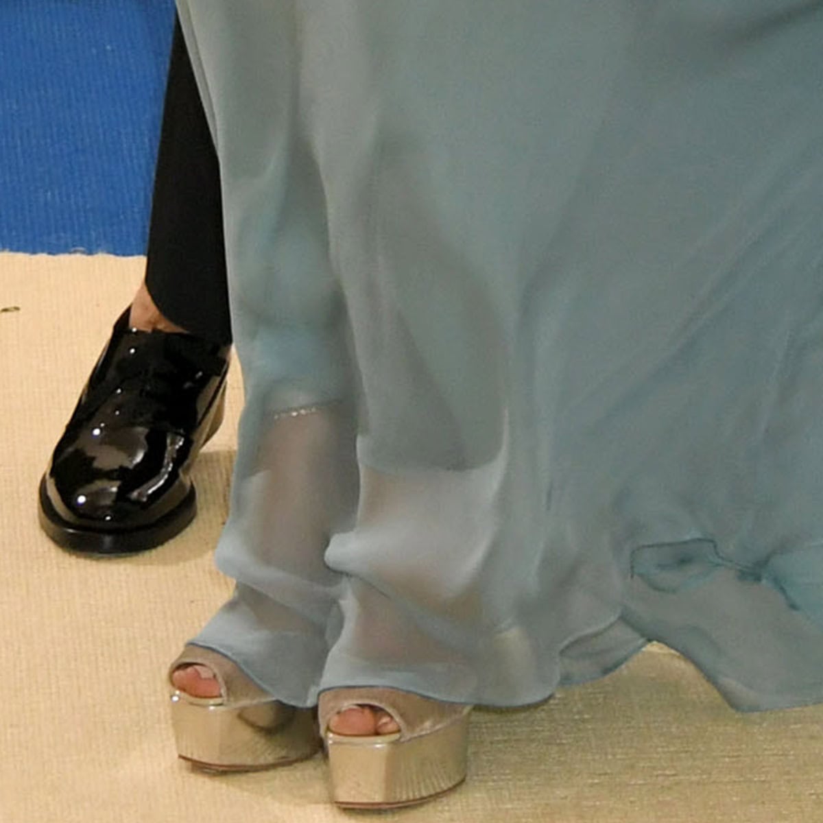 Jennifer Lopez's metallic silver-beige Giuseppe Zanotti Amelia platform sandals peek out beneath her Valentino gown, revealing a discreet ankle strap that helped secure the towering silhouette beneath the sweeping couture train