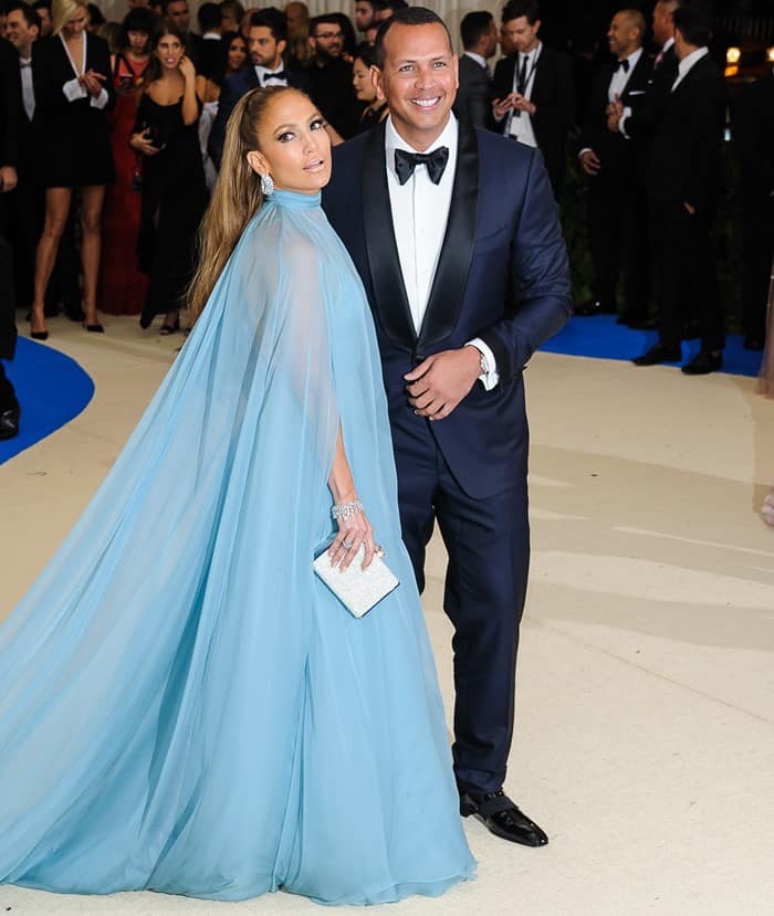 Jennifer Lopez made her couple debut with Alex Rodriguez at the Met Gala in a sweeping pale blue Valentino Haute Couture gown accented by a crystal Judith Leiber clutch and concealed Giuseppe Zanotti platform sandals