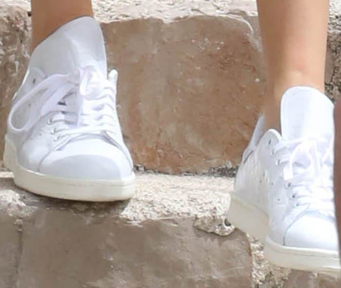 Kendall Jenner's classic white Adidas 'Stan Smith' sneakers feature a sleek leather upper, perforated three stripes on the sides and a low-profile rubber sole