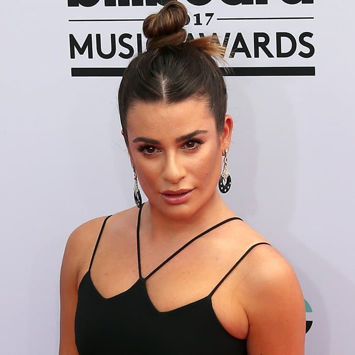 Lea Michele kept her look sleek with a high bun, letting her bold earrings and striking makeup take center stage
