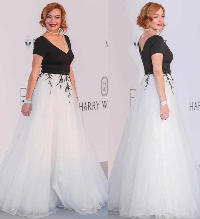 Channeling Old Hollywood elegance, Lindsay Lohan stuns in a black-and-white Christophe Guillarme gown with intricate embroidery and a classic pearl necklace at the 2017 amfAR Gala on May 25, 2017