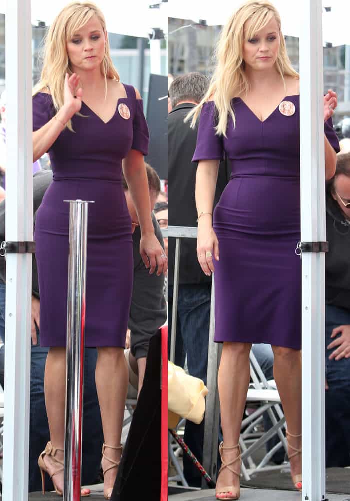 Reese Witherspoon pairs her bold purple Roland Mouret dress with elegant nude Christian Louboutin “Choca” sandals, adding a refined touch to her standout look