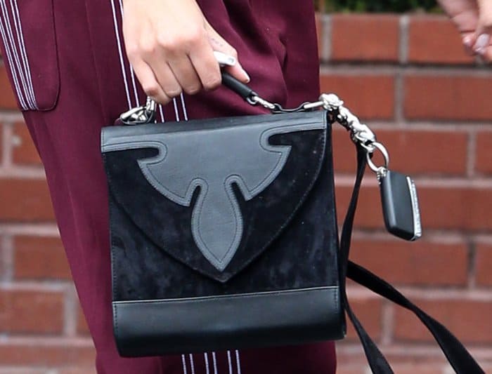 The Chrome Hearts Nataya bag features a beautiful mix of suede and leather, with a flap front closing