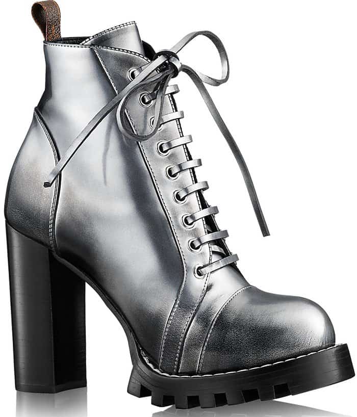 Louis Vuitton's metallic “Star Trail” ankle boots combine a rugged lug sole with a towering block heel, transforming a classic lace-up silhouette into a statement-making luxury boot