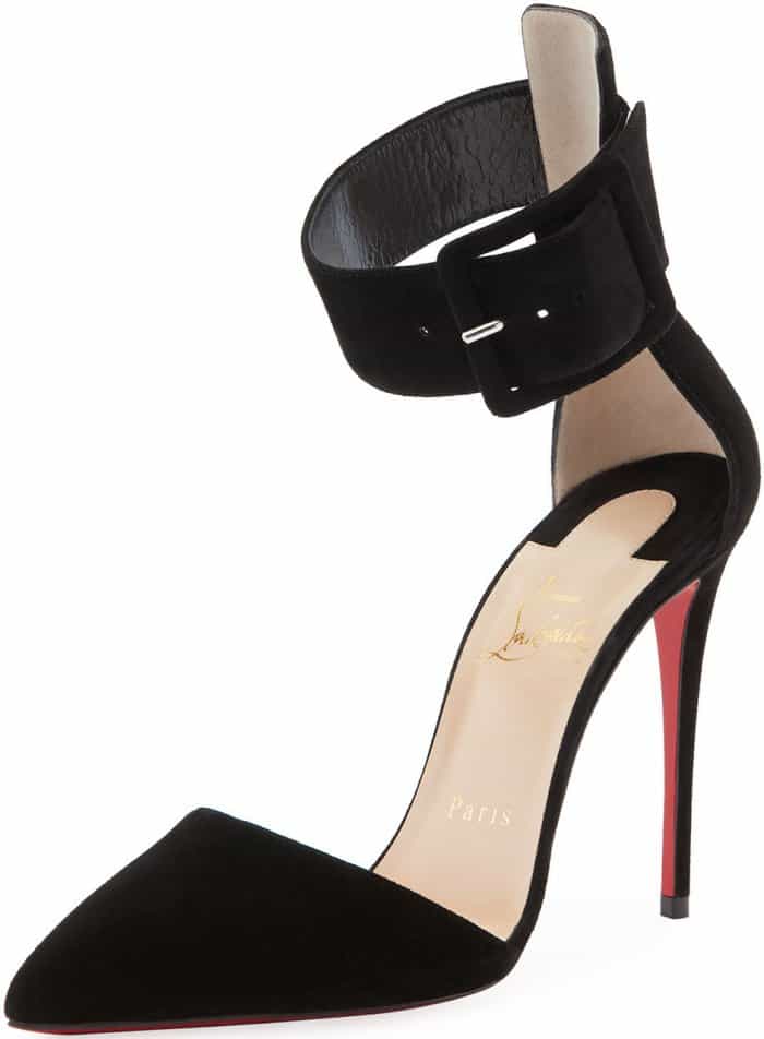 A sharply pointed toe, sculptural ankle cuff, and sky-high stiletto define the Christian Louboutin Harler pump, a black suede silhouette that blends restraint, edge, and unmistakable red-sole authority