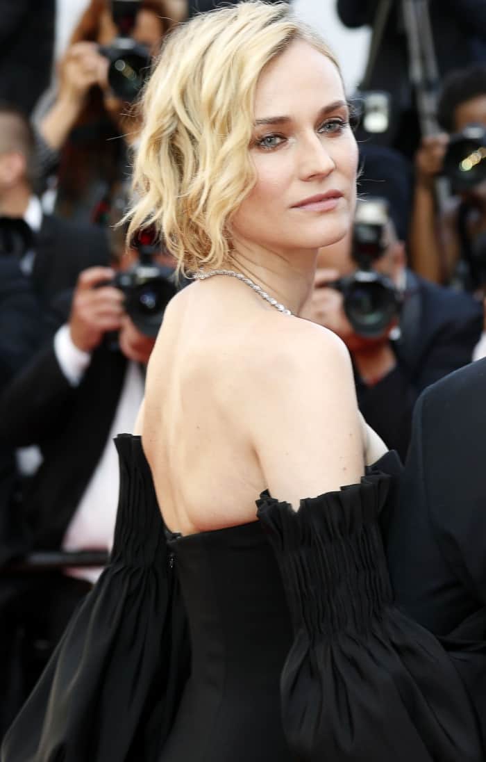 Diane Kruger paired softly textured waves with a diamond necklace, letting the sculptural neckline and exposed shoulders of her custom Jonathan Simkhai gown command attention
