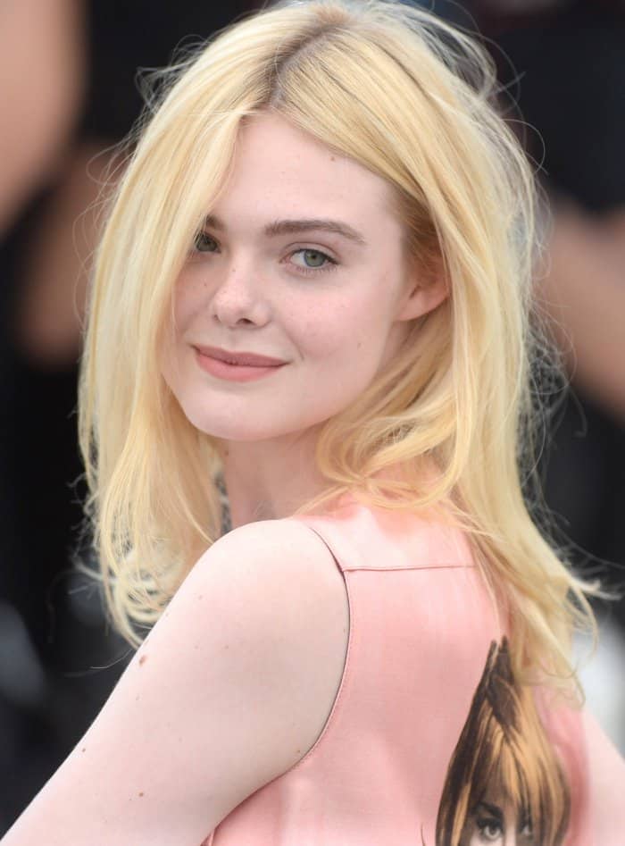 Elle Fanning wearing a Prada fall 2017 shift dress and Laurence Dacade "Lilas" satin pumps at the 70th Cannes Film Festival "How to Talk to Girls at Parties" photocall