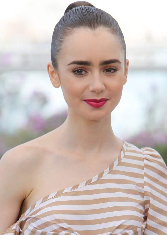 Lily Collins wearing a Johanna Ortiz ensemble and Saint Laurent "Janis" pumps at the 70th Cannes Film Festival "Okja" photocall