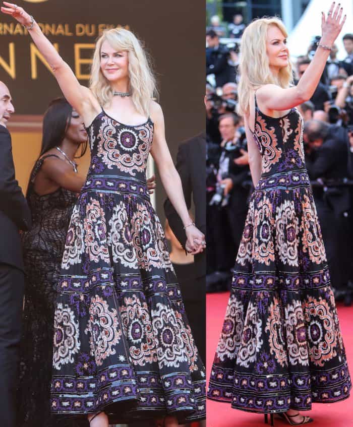 The intricately patterned Armani gown moves fluidly across the red carpet, anchored by slim black strappy heels that keep the silhouette elongated and controlled