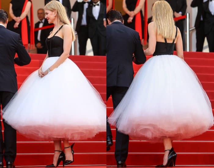 A sculptural tulle skirt gains contrast and control from sharp black ankle-strap pumps as she ascends the Cannes steps