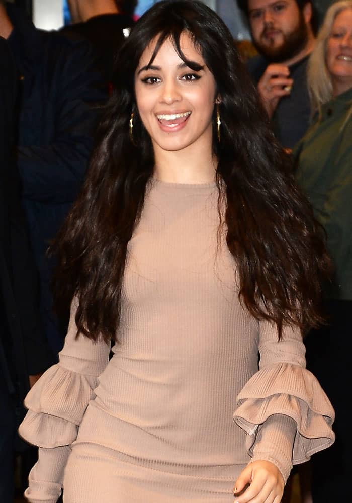 Camila Cabello softened her transition into solo stardom with a fitted taupe knit dress featuring dramatic ruffled sleeves during a BBC Radio 1 appearance in London on May 31, 2017