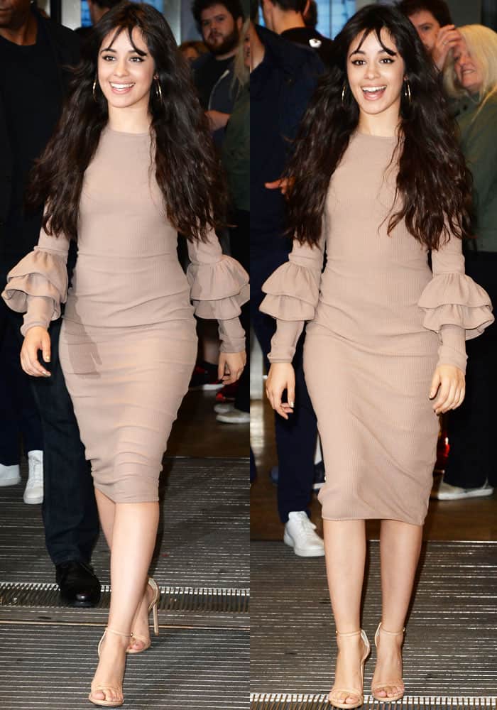 The neutral body-conscious midi dress marked a clear shift away from Fifth Harmony’s flashier styling, while nude Stuart Weitzman “Nudist” sandals kept the look sleek and understated