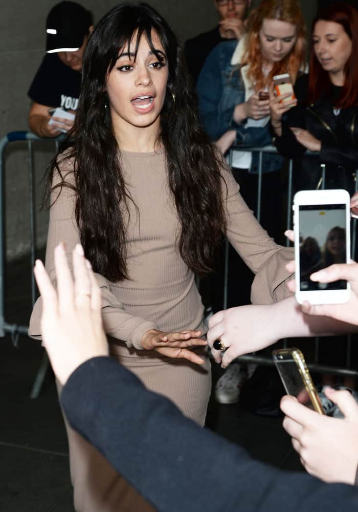 Camila Cabello paused to greet fans outside BBC Radio 1, pairing relaxed waves and gold hoops with one of the more pared-back outfits of her early solo era