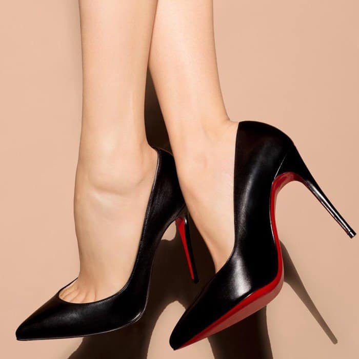 Christian Louboutin “Pigalle Follies” pumps in smooth black leather, featuring a sharply pointed toe, sleek 100mm stiletto heel, and the house’s iconic red lacquered sole for a timeless, leg-lengthening finish