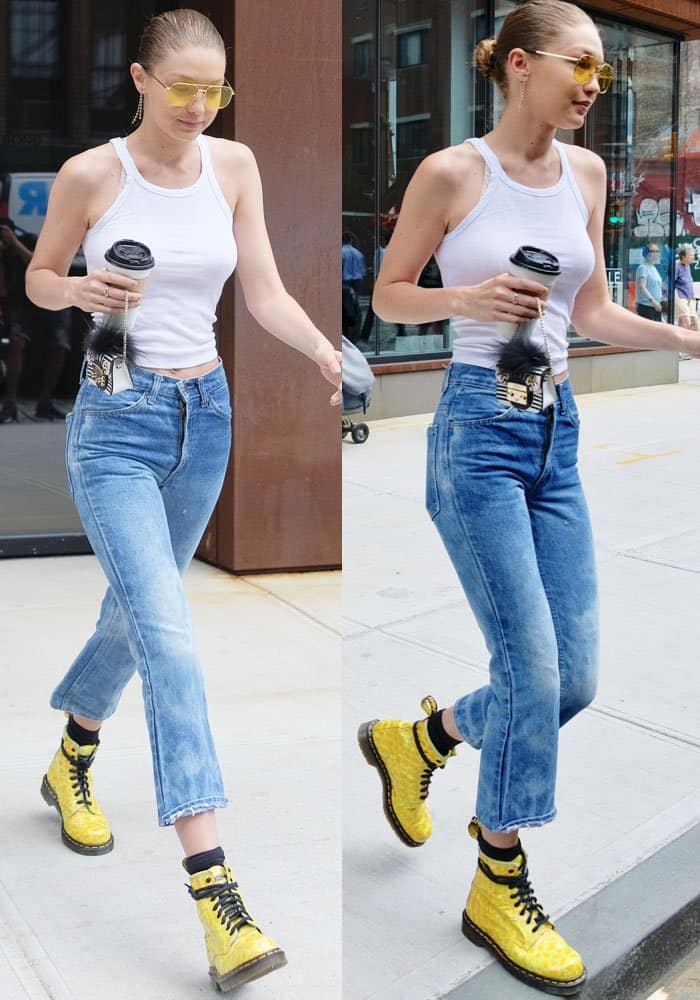 Gigi Hadid pairs her Re/done ribbed tank with cut-off jeans and striking yellow Dr. Martens boots, showcasing a casual yet coordinated street style