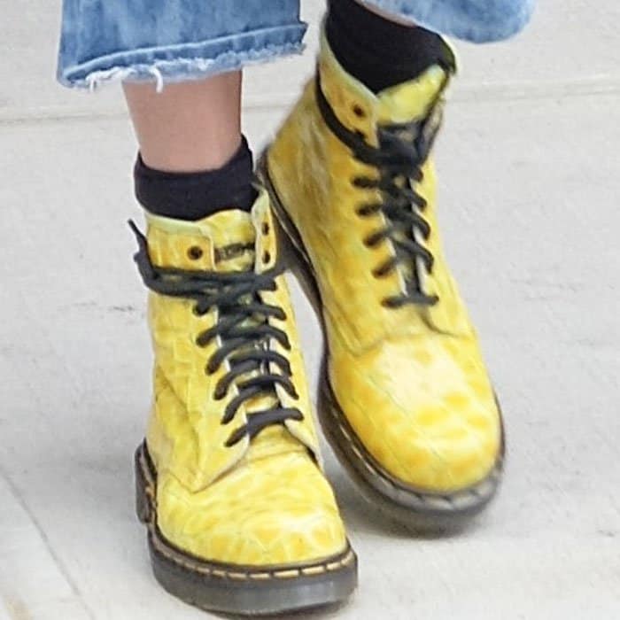 A closer look reveals the textured finish of Gigi Hadid's striking yellow Dr. Martens combat boots, which perfectly matched her sunglasses