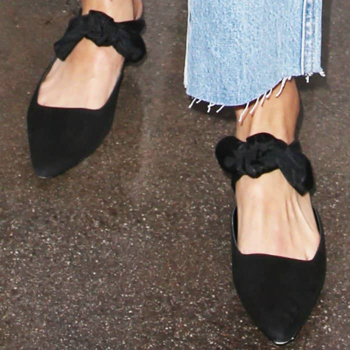 Jamie wears a pair of suede bow "Coco" mules by The Row