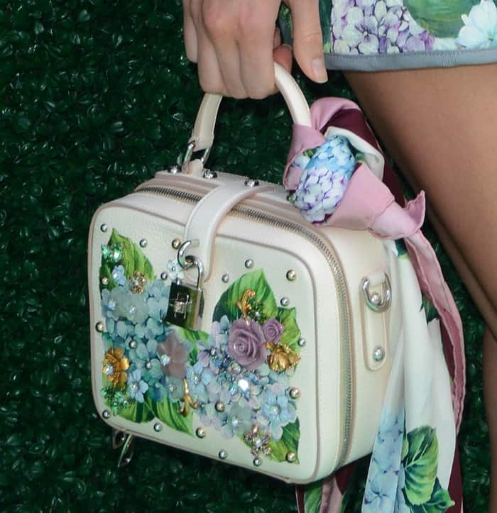 Kendall Jenner added a chic touch to her Dolce  Gabbana box bag by tying a matching silk scarf from the Ortensia collection, enhancing its elegant floral detailing
