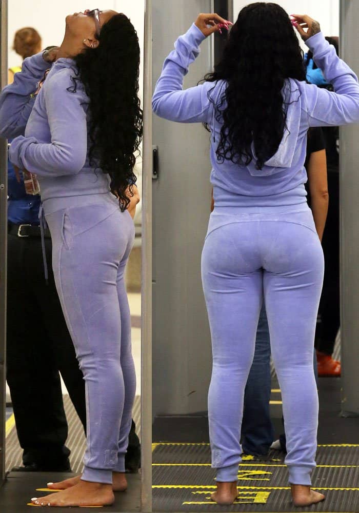 Rihanna stays comfortable as she removes her Balenciaga boots for security at LAX, showing off her casual lavender tracksuit and bare feet while maintaining her signature cool style