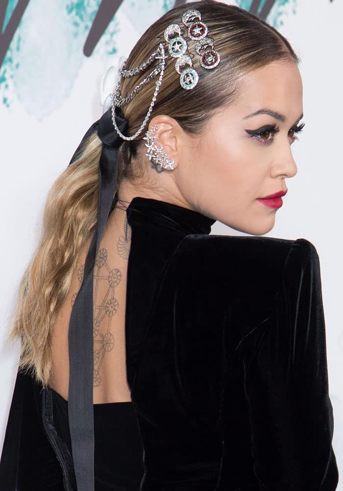 Rita puts her own twist to the look with badge hair pins