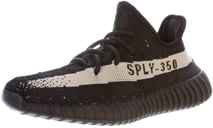 Adidas Yeezy Boost 350 V2 "Core Black White" sneakers feature black Primeknit uppers, a contrasting cream "SPLY-350" side stripe, and full-length Boost cushioning beneath semi-translucent ribbed midsoles