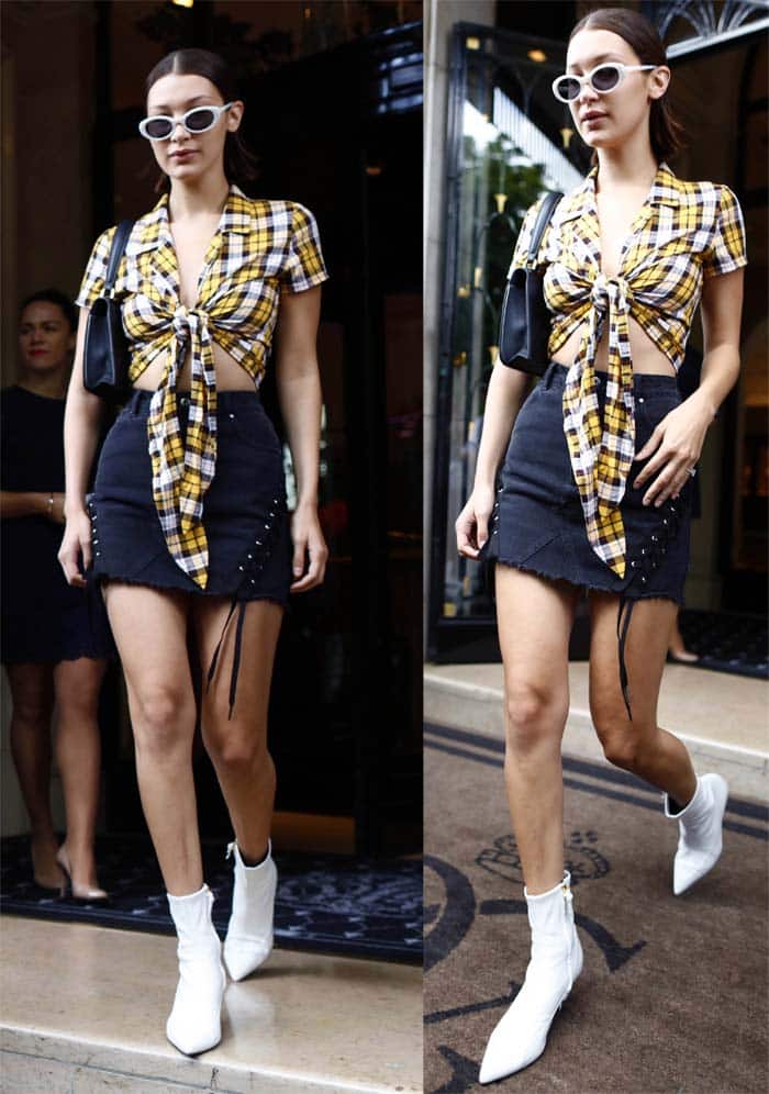 Bella Hadid in an I.Am.Gia top and denim skirt and Stuart Weitzman white "Clingy" booties