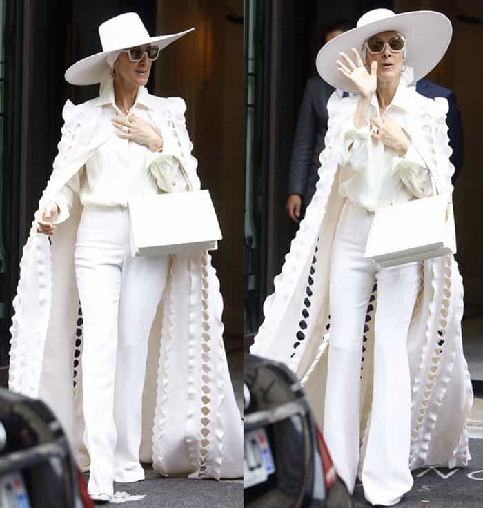 Celine Dion stuns in an all-white ensemble with a dramatic cape and oversized hat while leaving her hotel during Paris Fashion Week
