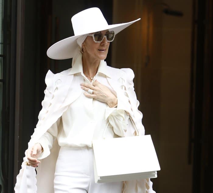 Celine Dion graced the streets of Paris in an all-white ensemble featuring a dramatic cape from Ralph  Russo’s Fall 2016 couture collection