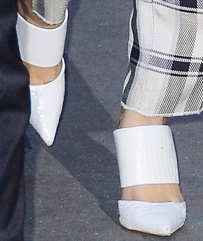 Bella Hadid elevated her plaid two-piece outfit with a touch of sophistication, thanks to her white Schutz "Quereda" mule pumps