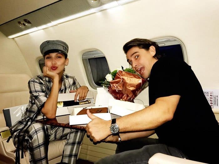 Bella Hadid on a private jet, celebrating her Parisian agent Julien Clisson's birthday en route to a Dior Makeup event