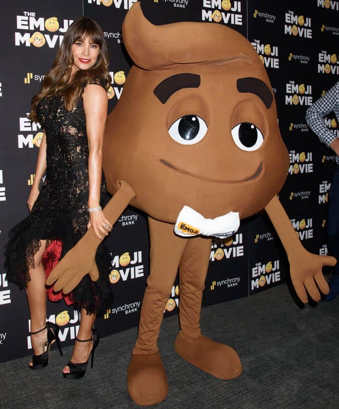 Sofia poses beside the hilarious poop emoji