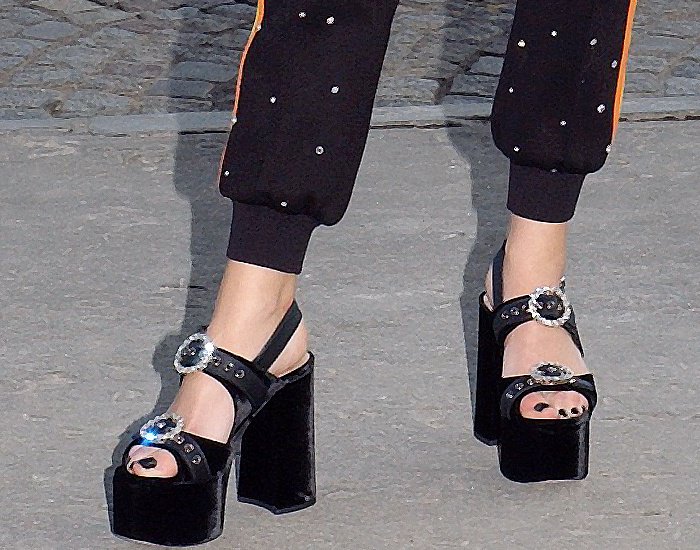 Anna Brewster wearing black embellished platform sandals at the Miu Miu Cruise 2018 fashion show during Paris Haute Couture Fashion Week