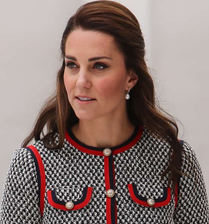 Kate completed her polished look with a half-up hairstyle and delicate pearl drop earrings that beautifully echoed the pearl buttons on her Gucci dress