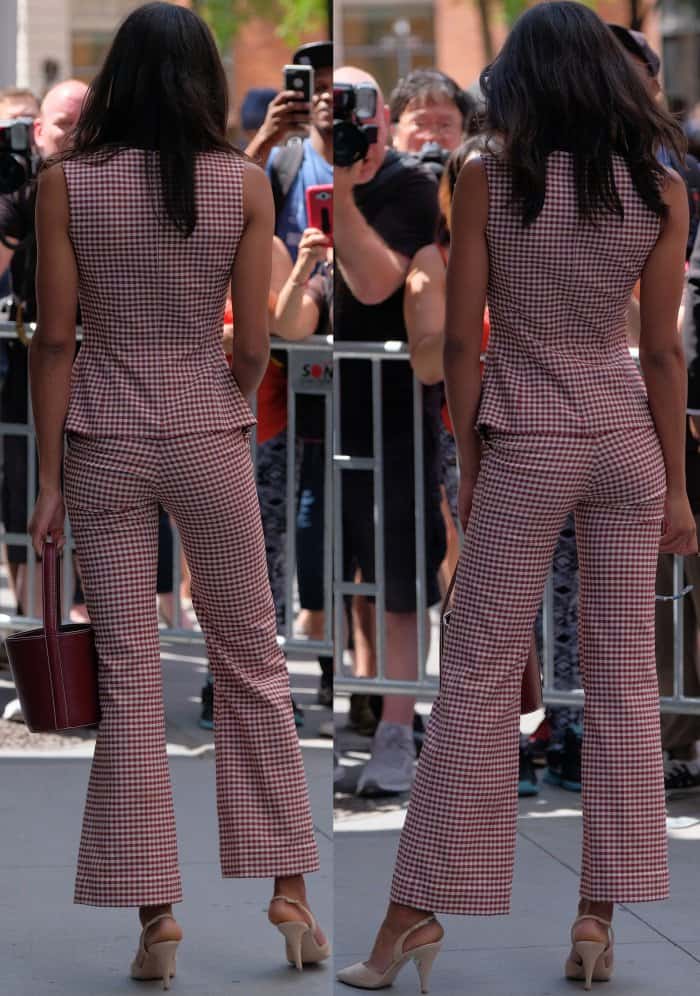 Laura Harrier’s center-parted hair cascades neatly down her back, while nude slingback heels—nearly matching her skin tone—create an elongating effect that enhances her already statuesque 5'8¾" frame