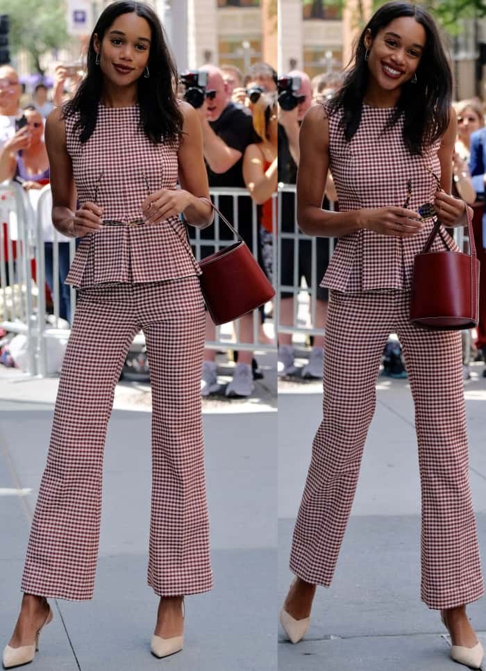 Laura Harrier steps out in a red-and-white gingham Brock Collection peplum set, pairing the look with sharp cream pointed-toe pumps and a rich maroon bucket bag for a polished appearance at AOL Build on June 26, 2017