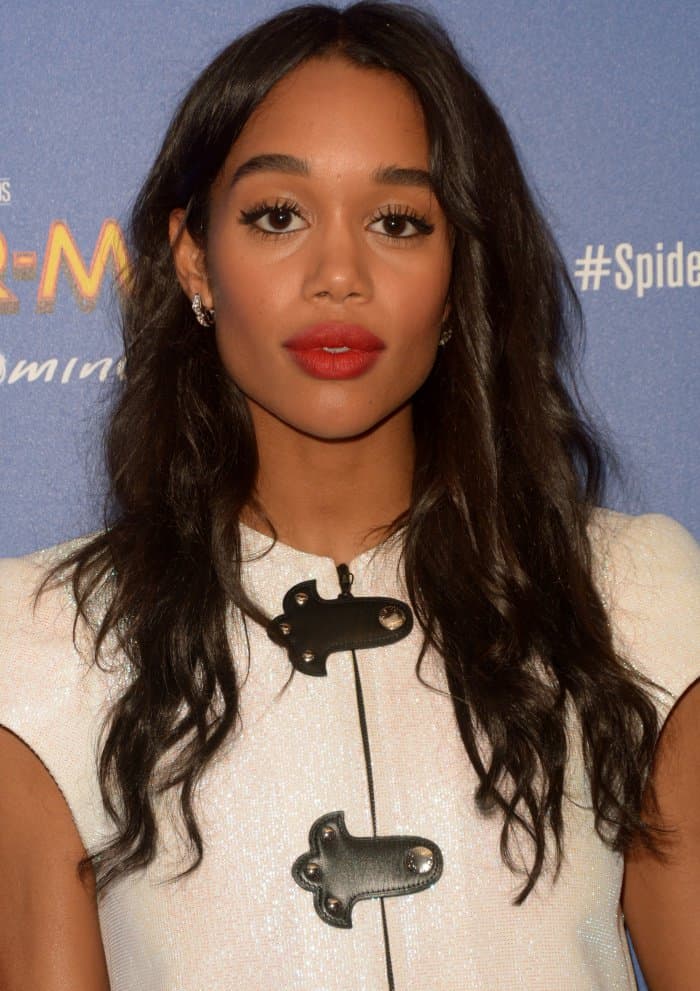 Laura Harrier wore her hair in soft, glossy waves parted down the center, with face-framing layers that highlighted her cheekbones and added effortless red carpet glamour to her structured Louis Vuitton ensemble