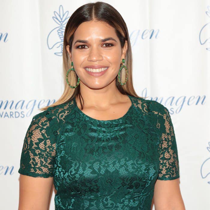 America Ferrera wearing an emerald green dress with lace overlay and accessorized with green hoop earrings