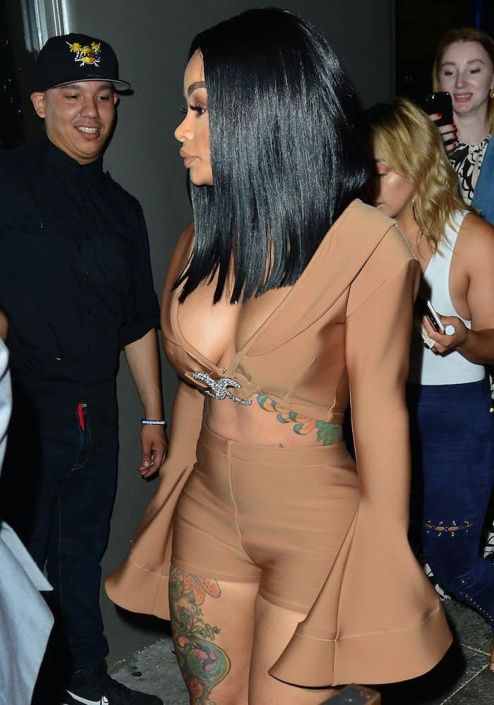 Blac Chyna flaunted her ample cleavage and her small waist in a nude crop top with long bell sleeves