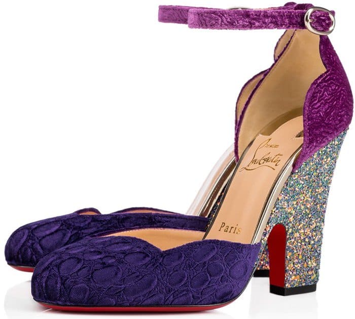Christian Louboutin's "Aketi" pumps combined textured purple velvet uppers with glitter-covered sculptural heels, transforming a classic d'Orsay silhouette into a statement-making design