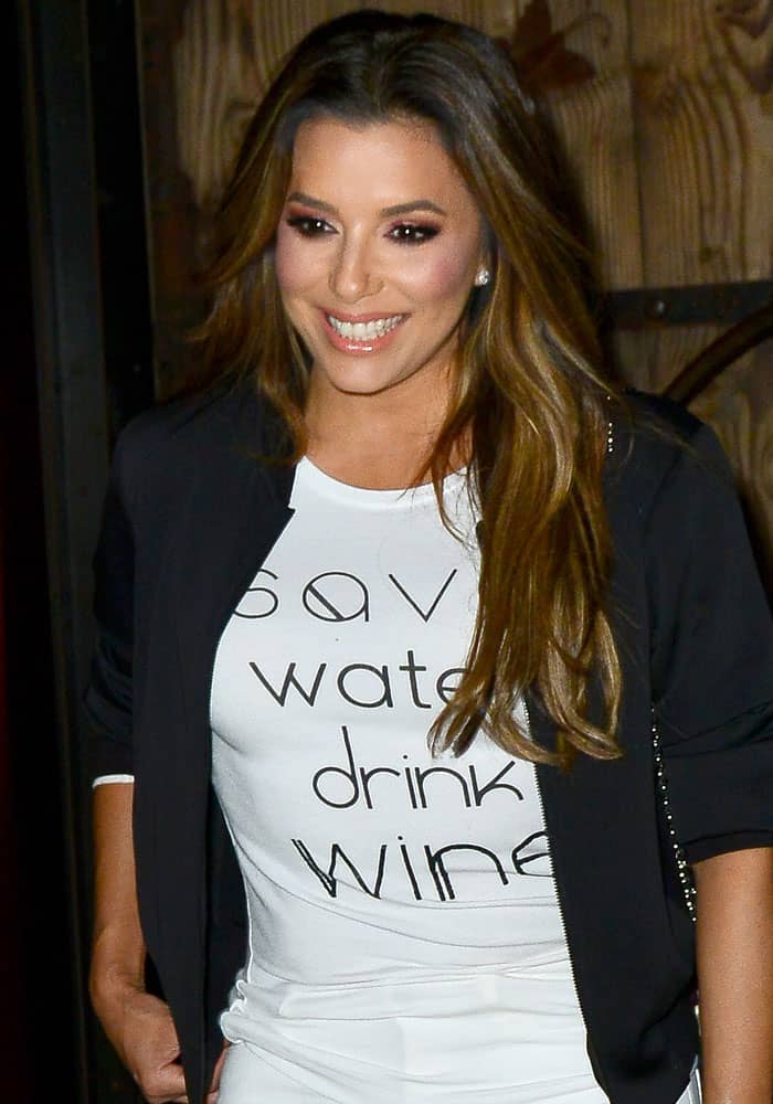 Eva Longoria exits TAO in Los Angeles in August 2017, wearing her eco‑chic “Save Water Drink Wine” T‑shirt — a glimpse of her casual-cool dinner ensemble