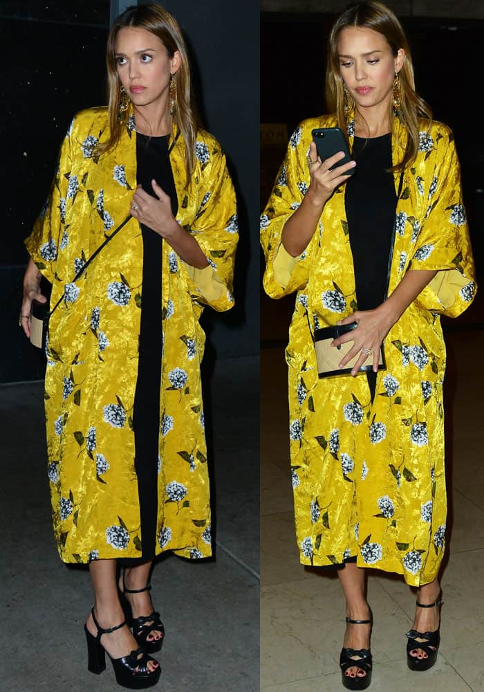 Jessica Alba pairs a bold yellow floral Topshop kimono with a black dress and Saint Laurent “Candy” platform sandals while attending Hamilton in Hollywood.