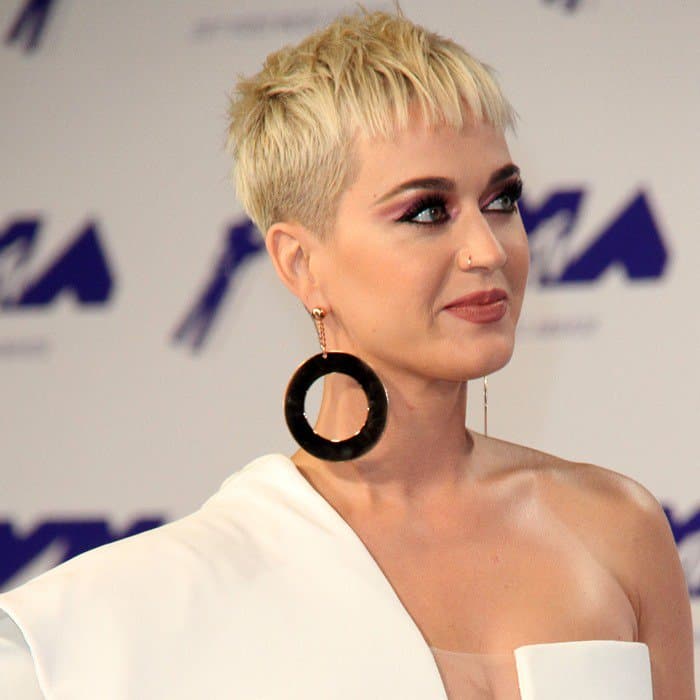 Katy Perry accessorized her avant-garde look with oversized black circular hoop earrings by Armani