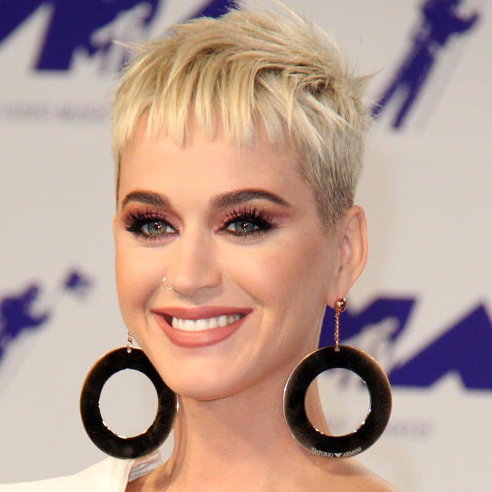 In this close-up, Katy Perry shows off a dainty nose ring and her radiant smile, highlighting her straight white teeth